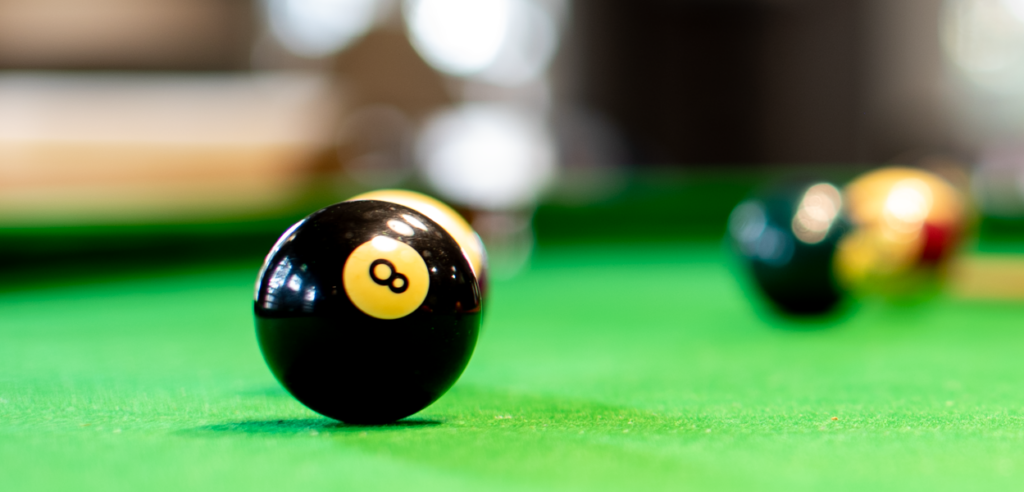The 8 ball waits to be potted on the championship sized billiard table